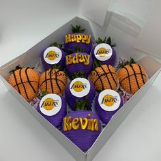 a box filled with purple and orange decorated strawberries