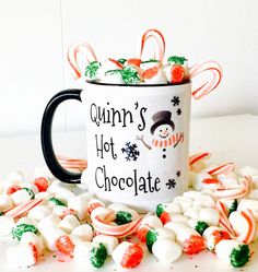 a coffee mug with candy canes and marshmallows around it