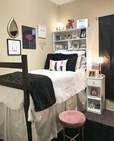 a bed room with a neatly made bed next to a book shelf and a chair