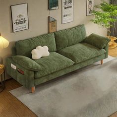 a green couch sitting on top of a rug in a living room