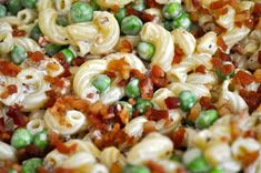 pasta with peas and bacon is mixed together in a mixture to make a tasty looking dish