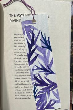 a bookmark with an image of purple leaves and the words, the psychic divine