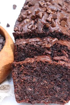 a loaf of chocolate cake next to a bowl of chocolate chips