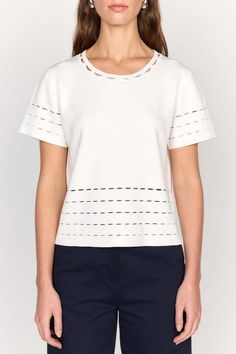 The clio top is an elevated stable white tee. this top is cut in a knit blend and features a unique laser cut detailing at the neck sleeve and hem.    composition: knit blend  care: dry clean only  imported. Elegant Crew Neck Top In Pointelle Knit, Open Knit Workwear Tops, Open Knit Tops For Workwear, Open Knit Top For Work, Chic Pointelle Knit Crew Neck Top, Chic Crew Neck Pointelle Knit Top, White Fine Knit Top With Short Sleeves, Chic Open Knit Top For Workwear, Casual Open Knit Tops For Work