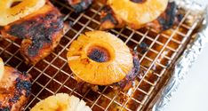 grilled pineapples and meat on a cooling rack