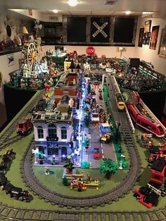 a model train station with trains and cars on the tracks