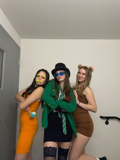 three women dressed up in costume posing for the camera with their arms around each other