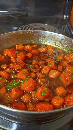 a pan filled with cooked carrots on top of a stove