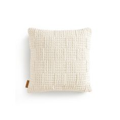 a white pillow on a white wall