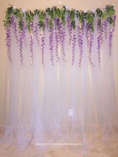 purple flowers are growing on the sheer curtain