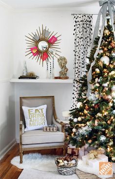 a decorated christmas tree in the corner of a living room with white and gold decor