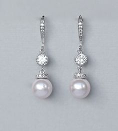 "Ivory white pearl drop bridal earrings are made with a beautiful Swarovski pearl with a crystal studded white gold cap and completed with a sparkling channel set cubic zircon and zircon studded french hook ear wire. A perfect little twist on an elegant classic! Select your color from our extensive pearl collection. Measurement: L- approx 1 3/4\" (4cm) Post is nickel free. 💞 All our jewelry is presented in velvet pouches and high quality elegant, padded boxes ready for gifting 💝 ♥♥Models own e Luxury Pink Pearl Earrings, Cheap Pink Pearl Drop Earrings, Cheap Pink Pearl Earrings As Gift, Cheap Pink Pearl Earrings For Gift, Luxury Pink Round Pearl Earrings, Luxury Pink Pearl Earrings For Formal Occasions, Cheap Pink Pearl Earrings, Affordable Pink Elegant Pearl Earrings, Bridal Drop Earrings