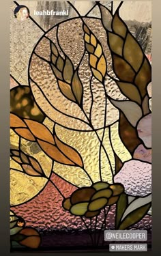 a stained glass window with leaves on it