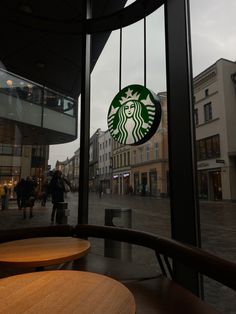 a starbucks sign is seen through the window