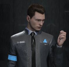 a man in a suit and tie standing in the rain with his hand on his hip