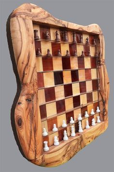 a wooden chess board with many pieces on it