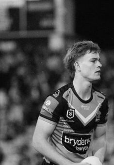 a black and white photo of a rugby player