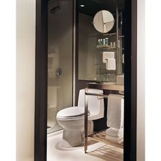 a bathroom with a toilet, sink and shower in it's glass walled stall