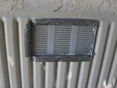 a radiator is being installed on the side of a wall with plastic covering it