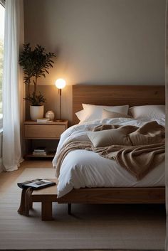 a large bed sitting next to a window in a bedroom