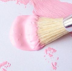 a brush with pink paint on it