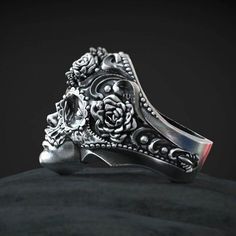 Dia del Muerto, or day of the dead, is a unique day where you have to honor the memory of the loved ones that are gone. this skull ring will put some flowers on your memories. The Day of the Dead or in Spanish Dia de Muertos is a particular form of the feast of the dead typical of current Mexican culture which is also seen in the southwest of the United States among the Hispanic community of Mexican origin. This dia de Los Muertos skull ring is perfect for you if you do like the Day of the Dead, Mexican Gothic, Sugar Skull Ring, Skull Day Of The Dead, Halloween Ring, Groom Ring, Skull Rings, Casual Rings, Sterling Silver Promise Rings, Biker Jewelry