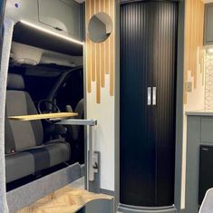 the interior of an rv with its door open and wood trimmings on it