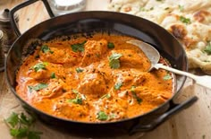 a pan filled with food sitting on top of a wooden table