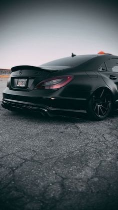 a black sports car parked in a parking lot