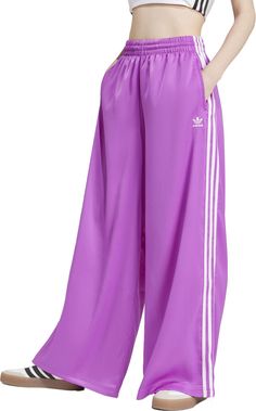 These wide-leg track pants embrace the heritage of adidas while looking ahead to the future. You'll move with ease thanks to the loose, flowing fit that creates an effortlessly casual silhouette. Crafted from luxurious satin, they exude a sense of elegance perfect for a night out or a casual brunch. Signature 3-Stripes run down the sides of the legs, a detail as timeless as the look itself. Fit & Design: Loose fit Drawcord on elastic waist Wide legs Side seam pockets Additional Details: This product is made with at least 70% recycled materials Wide Leg Track Pants, Womens Athletic Outfits, Adidas Originals Women, Athletic Apparel, Athletic Outfits, To The Future, Wide Legs, Recycled Materials, Track Pants