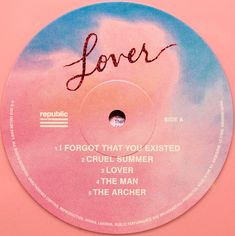 a pink and blue disc with the word lover written on it in cursive writing