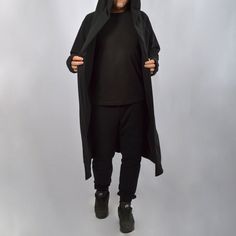 Very cool and comfortable long cardigan. Nice dense fabric makes it cozy. A truly multifunctional hooded cloak made from extremely soft and durable high quality cotton. Special thumb holes in the end of the sleeves. It looks very cool and easily creates a unique look. It goes well with streetwear, gothic, punk, cyberpunk, post-apocalyptic, as easily as it fits in everyday wear. In the options, you can add pockets or change the length by shortening or lengthening this cardigan as you like. We wil Unisex Cardigan, Steampunk Coat, Cardigan With Hood, Hooded Cloak, Gothic Punk, Cardigan Long, Shortening, Post Apocalyptic, Urban Outfits