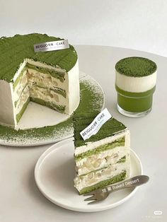 there is a green cake on the table with two slices cut out and one piece missing