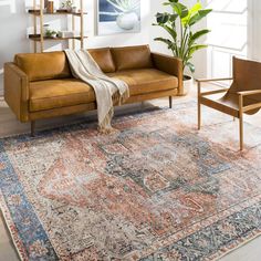 a living room filled with furniture and a rug