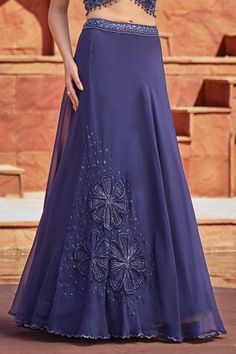 Navy blue off shoulder blouse with handcrafted embroidery using tonal sequins, beads and cutdana. Comes with big applique flower embroidered lehenga skirt. - Aza Fashions Elegant Evening Georgette Skirt, Elegant Fitted Skirt With Intricate Embroidery, Elegant Blue Wedding Skirt, Elegant Embellished Georgette Skirt, Elegant Long Skirt With Resham Embroidery, Elegant Floral Embroidered Lehenga For Evening, Elegant Blue Floor-length Skirt, Lehenga Pattern, Lehenga Skirt