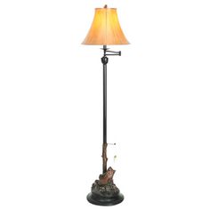 a lamp that is on top of a stand with a bird on it's arm