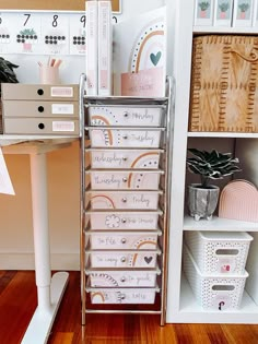 a white desk with lots of drawers and boxes on it's shelf next to a wooden floor