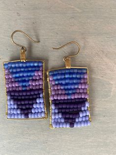 Colorful wired wrapped earrings in a 4 shades of purple . 2 inches in length these earrings have a perfect shape and size . Artisan Purple Wire Wrapped Jewelry, Unique Single Purple Earring, Purple Single Drop Earring, Artisan Purple Beaded Dangle Earrings, Single Purple Drop Earring, Handmade Lavender Beaded Earrings For Gift, Unique Purple Earrings With Ear Wire, Artisan Beaded Purple Earrings, Artisan Purple Beaded Earrings