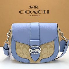 Signature Coated Canvas, Smooth Leather And Refined Pebble Leather Inside Multifunction Pockets Snap Closure, Fabric Lining Outside Open Pocket Detachable Strap With 20 3/4" Drop For Shoulder Or Crossbody Wear 8 1/4" (L) X 6 3/4" (H) X 2 3/4" (W) Style No. C2806 Blue Luxury Leather Saddle Bag, Luxury Blue Leather Saddle Bag, Elegant Blue Saddle Bag For Everyday Use, Blue Saddle Shoulder Bag With Detachable Strap, Blue Saddle Bag With Detachable Strap, Blue Satchel Saddle Bag With Removable Pouch, Blue Saddle Bag Satchel With Removable Pouch, Blue Saddle Bag With Removable Pouch, Blue Saddle Bag With Removable Pouch Satchel