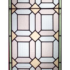 an old stained glass window with geometric designs