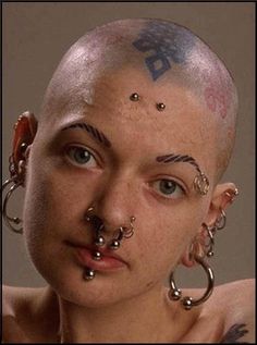 a woman with piercings on her head and nose