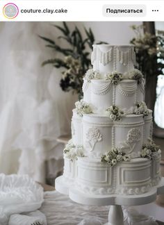 a white wedding cake sitting on top of a table