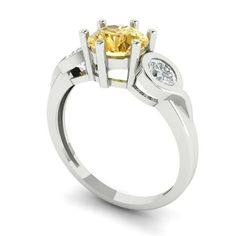 a yellow diamond ring with two diamonds on the side and one stone in the center