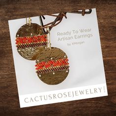 a pair of earrings on top of a piece of paper with the title ready to wear artisan earrings