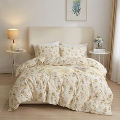 a bed with white sheets and yellow flowers on it