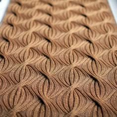 a close up view of a knitted surface with wavy lines on the top and bottom