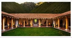 an outdoor courtyard with grass and mountains in the backgrouds, surrounded by greenery