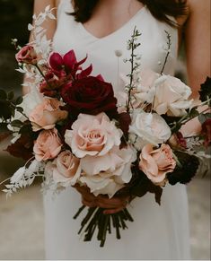 a woman holding a bouquet of flowers in her hand and instagram on the phone