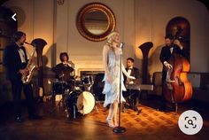 a group of people that are standing in front of musical instruments