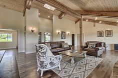 a living room filled with furniture and wooden floors